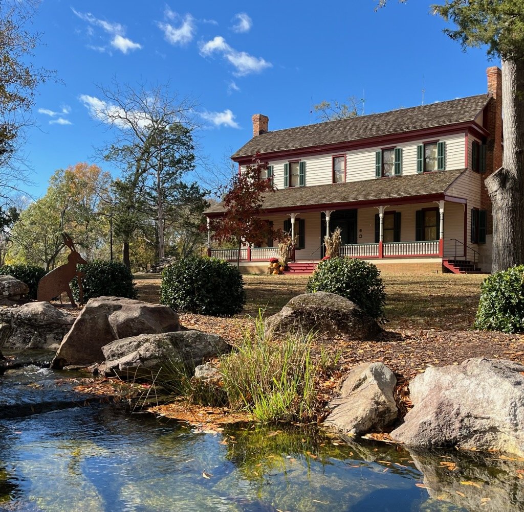 The spring park inn with a pond at the front